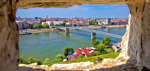 Novi Sad and the Danube river seen through a stone window from Petrovaradin in Serbia