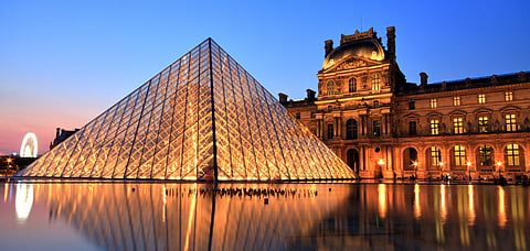 The Louvre Pyramid beckons with its contemporary allure