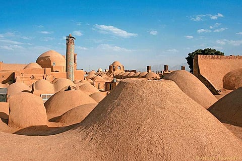 Cupolas of the bazaar and, in the foreground, a windcatcher in Yazd