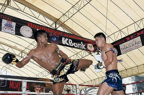 Thailand's Welterweight champion Sombat 'Buakaw' Banchamek delivers a knockout kick to his Chinese challenger Wei Chao Chen