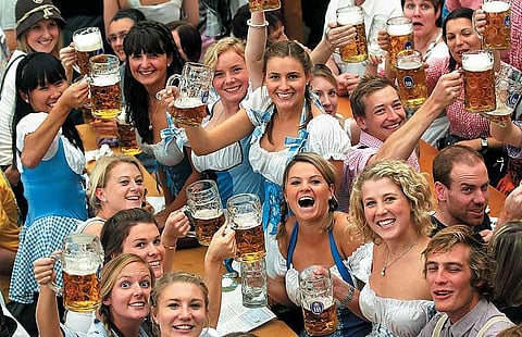Beer and smiles at the Oktoberfest in Munich, an annual funfair that starts in September and ends in October