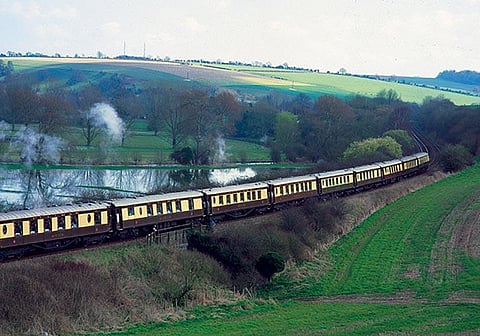 The British Pullman winds through the picturesque British countryside
