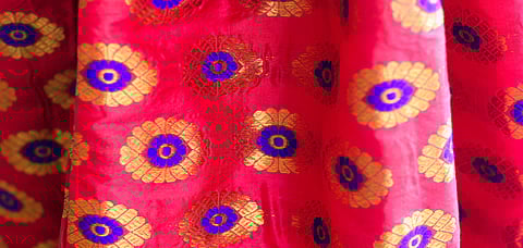The paat silk mekhela chadars have intricate designs made out of golden silk threads or guna all over