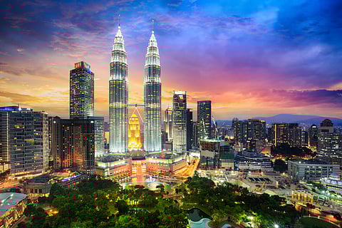 Kuala lumpur city skyline at dusk, Malaysia. Photo Credit Shutterstock