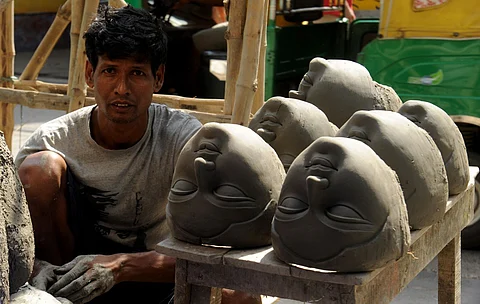 At a potter's workshop in Kumortuli