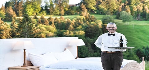 A picture of the butler standing beside the Zero Star hotel room