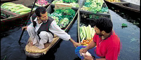 Vegetable vendors greet each other at the Floating Market