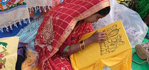 A rural woman painting handicrafts in Kolkata