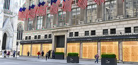 Shut storefronts in New York City boarded up with plywood