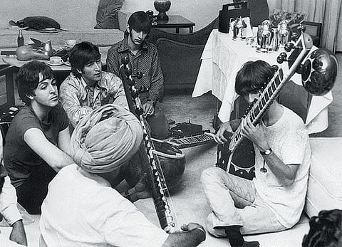 George Harrison playing a sitar