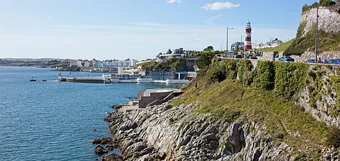 Plymouth's seafront at Hoe Park with the Tinside Lido and Smeaton's Tower in England