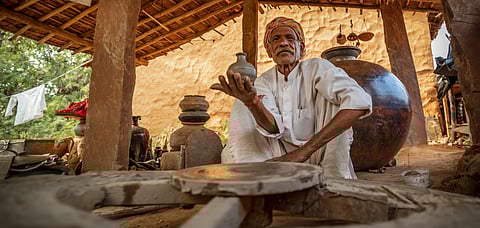 A potter shows off his ceramic works