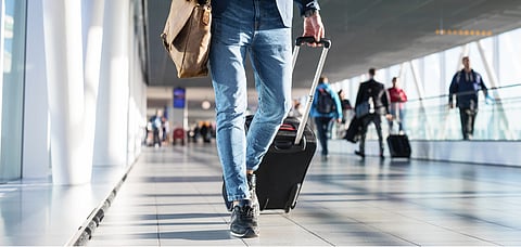 Representative image Man walking in airport terminal