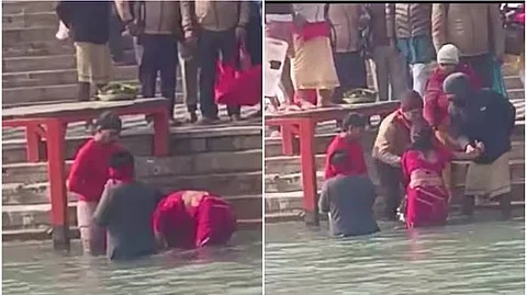 গঙ্গায় ডোবানো হচ্ছে শিশুটিকে