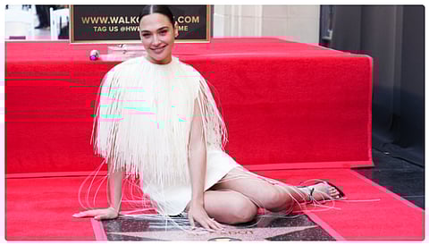 Israeli actress Gal Gadot was honored with a star on the Hollywood Walk of Fame on March 18, 2025. The ceremony faced disruptions due to protests from both pro-Palestinian and pro-Israel demonstrators, reflecting tensions surrounding her public support for Israel.
During the event, Gadot expressed her gratitude, stating, "I feel like I'm the luckiest woman I know right now. I'm just a girl from a town in Israel, and I could never imagine such a moment."
Despite the protests, the ceremony proceeded, with Gadot acknowledging her Israeli roots and the journey that led her to this recognition.
Online reactions to Gadot's accolade were mixed. Some social media users questioned the merit of the honor, referencing her performance in the film "Red Notice." One comment read, "A star for her scintillating performance in 'Red Notice'? Really?" Others defended Gadot, highlighting her roles in successful franchises like "Wonder Woman" and "Fast & Furious."
Gadot's recent public support for Israel, particularly following events in October 2023, has sparked significant backlash and debates online. She expressed surprise at the negative reactions but maintained her stance, stating, "I had to speak up."
The controversy extended to her professional relationships, reportedly causing tension with her "Snow White" co-star Rachel Zegler, an advocate for the Free Palestine movement. This discord has led to separate promotional efforts for their upcoming film.
Despite the mixed reactions and challenges, Gadot's recognition on the Hollywood Walk of Fame marks a significant milestone in her career.