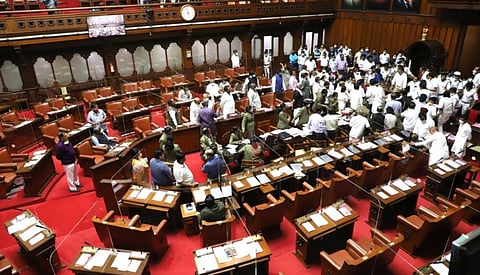 Bengaluru: Chaos prevailed in the Karnataka Legislative Council when Deputy Chairman S.L. Dharme Gowda occupied the chair even before the house bell stopped ringing on Tuesday. Angered over this, the Congress members tried to drag him off his chair in unprecedented scenes in a one-day sitting of the state's upper house, in Bengaluru on Dec 15, 2020. As the house bell rang, Deputy Chairman Gowda of the Janata Dal (S), occupied the chair and closed the entrance to prevent the Chairman entering the house as a result of which pandemonium broke out with Congress members pushing Gowda from his seat while BJP leaders tried to ensure he remained seated on the chair. (Photo: IANS)