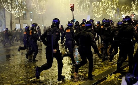 पॅरीसमध्ये हिंसक जमावाला पांगविताना पोलीस.