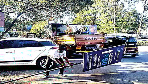 सातपूर : विभागामधील अनधिकृत फलक हटवताना मनपा कर्मचारी व पथक. (छाया : सागर आनप)