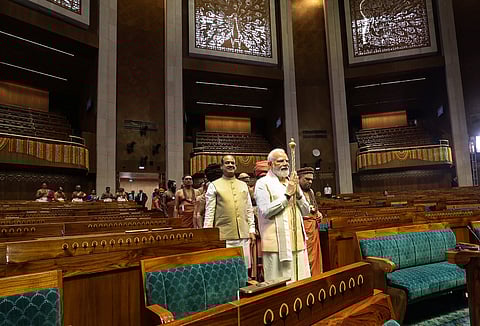 **EDS: TWITTER IMAGE VIA @narendramodi** New Delhi: Prime Minister Narendra Modi carries the 'Sengol' in a procession before installing it in the Lok Sabha chamber at the inauguration of the new Parliament building, in New Delhi, Sunday, May 28, 2023. Lok Sabha Speaker Om Birla is also seen. (PTI Photo)(PTI05_28_2023_000046B)