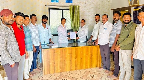 फोटो : सर्वपक्षीय नेत्यांना गावबंदी करतानाचे पत्र ग्रामसेविका चौधरी यांना देताना ग्रामस्थ.