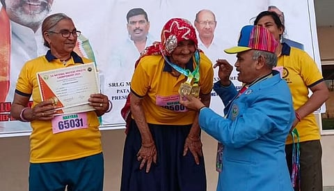 रामबाईं यांना सुवर्णपदक देऊन सन्मानित करताना आयोजक.