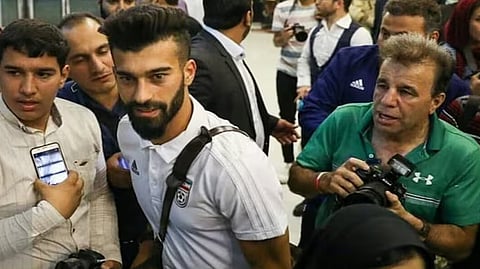 iranian footballer faces controversial hug with female fan