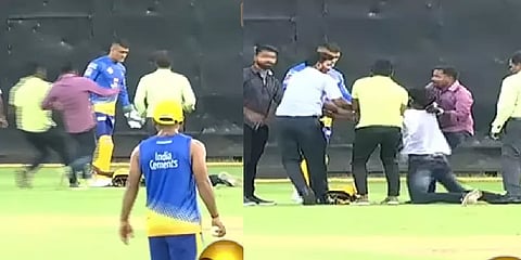 ஓடி வந்து சறுக்கி விழுந்து தோனியின் கால்களைப் பிடித்த ரசிகர் - வீடியோ