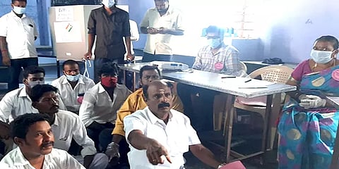 மின்னணு இயந்திரத்தில் புகைப்படம் மறைக்கப்பட்டதாக புகார்: தர்ணாவில் ஈடுபட்ட அமமுக வேட்பாளர்