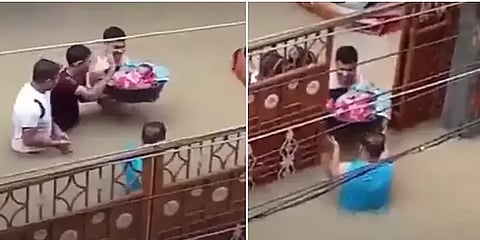 அசாம்: இடுப்பளவு வெள்ளத்தில் பிறந்த குழந்தையை சுமந்து சென்ற தந்தை - வைரலாகும் வீடியோ