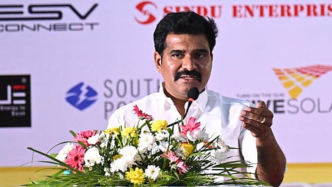 Tamil Nadu Energy Resources Minister C.T.R. Nirmal Kumar speaking at a podium during an energy-sector event, with event logos visible in the background.