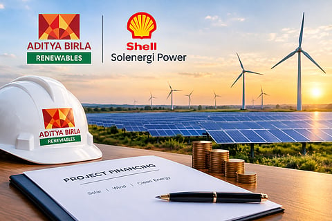 Solar panels and wind turbines at sunset, with an Aditya Birla Renewables-branded hard hat, project financing documents and stacks of coins in the foreground, alongside Aditya Birla and Shell Solenergi Power branding.
