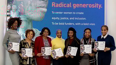 (Left to Right): Honorees Ngozi Okaro, Dr. Danielle R. Moss Cox, Marjorie Cadogan, Soffiyah Elijah, Dominic-Madori Davis, 
Rashidah Siddiqui, and Rosemonde Pierre-Louis in front of The New York Women’s Foundation’s Black History Month
Display in World Trade Center