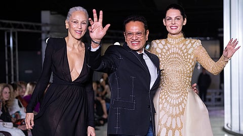 Designer Naeem Khan (centre) closes the Autumn/Winter 2024 runway with two of the collection models.