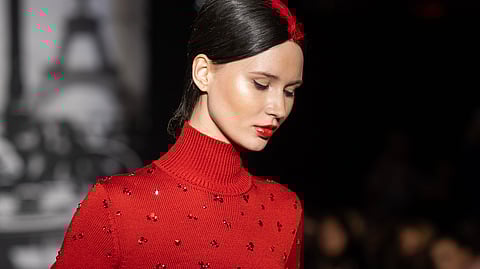 A model in dramatic crimson is the picture of elegance at Zang Toi's House of Toi 'Amazing Grace' Autumn/Winter 2024 runway show during New York Fashion Week.