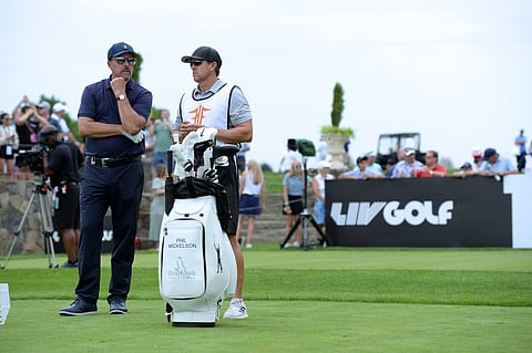 Phil Mickelson (L) talks to his Caddie at the 16th Tee during the LIV Golf Tournament held at the Trump National Golf Club in Bedminster,NJ.