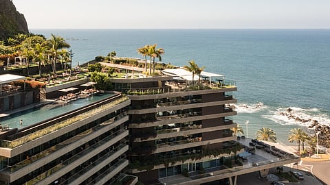 Aerial view of Saccharum hotel cascading toward the ocean