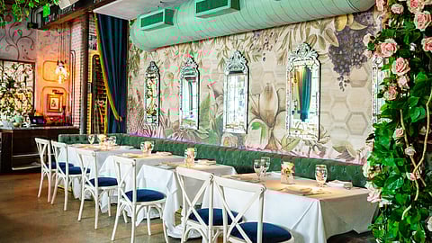 Chic dining room at Kiki on the River with floral décor and mirrors