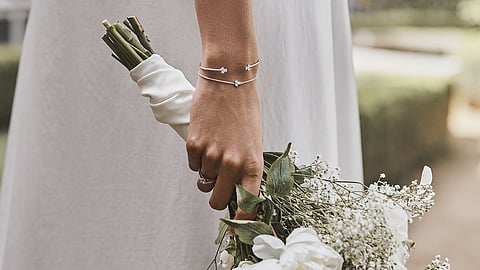 Professionals planning exhibition stand design with laptop and blueprints