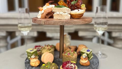 Afternoon tea tower with savory bites, sweets, and champagne at La Macaria