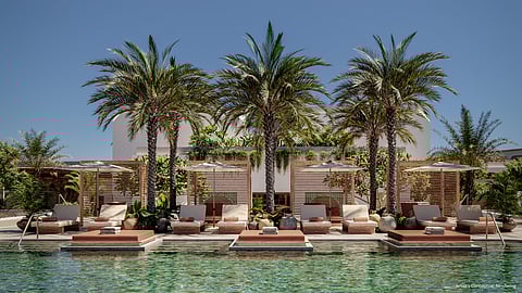 Rooftop poolside cabanas framed by palm trees at Alhambra Parc
