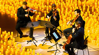 Quartet performs in Paradise Plaza surrounded by candlelights