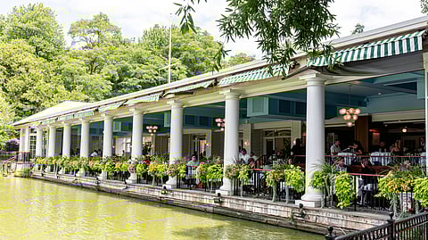 Central Park Boathouse terrace dining overlooking the lake with greenery