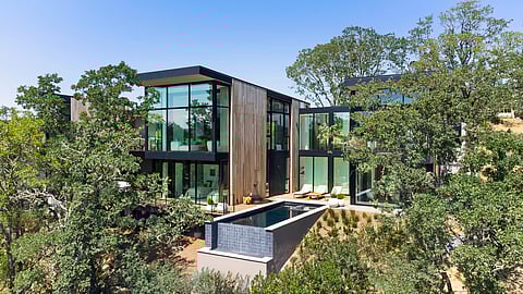Modern glass estate home with pool surrounded by Sonoma oak trees