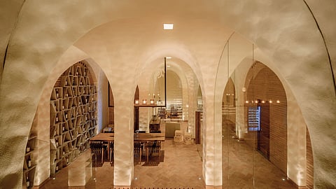 An arched wine cellar at La Casa de la Playa exudes timeless elegance