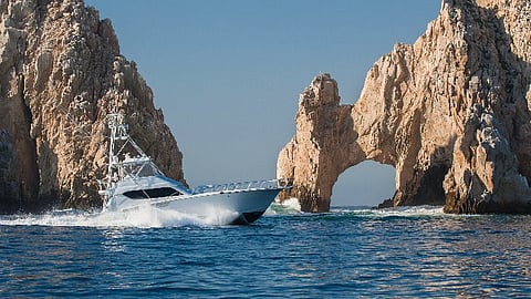 Fishing boat cruises past El Arco in Los Cabos