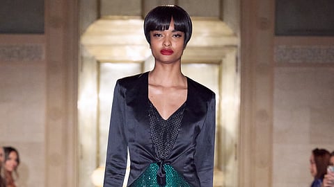 Model in black cape and glittering suit on Malan Breton SS26 runway