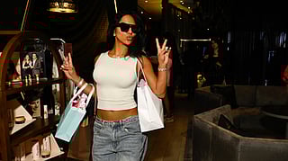 Guest poses with gift bags at W New York – Times Square NYFW events