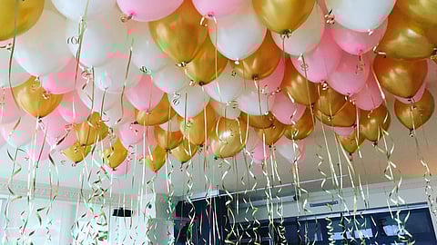Colorful helium balloons floating at a festive celebration