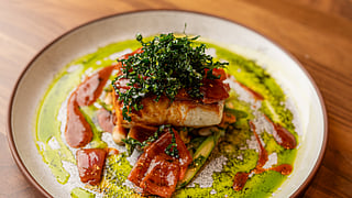 Colorful Peruvian dish topped with greens and sauce at Mission Ceviche