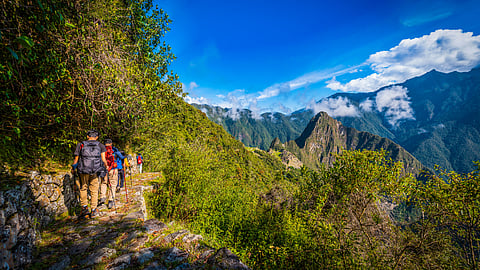 Group of trekkers on a stone path along the Inca Trail near Machu Picchu